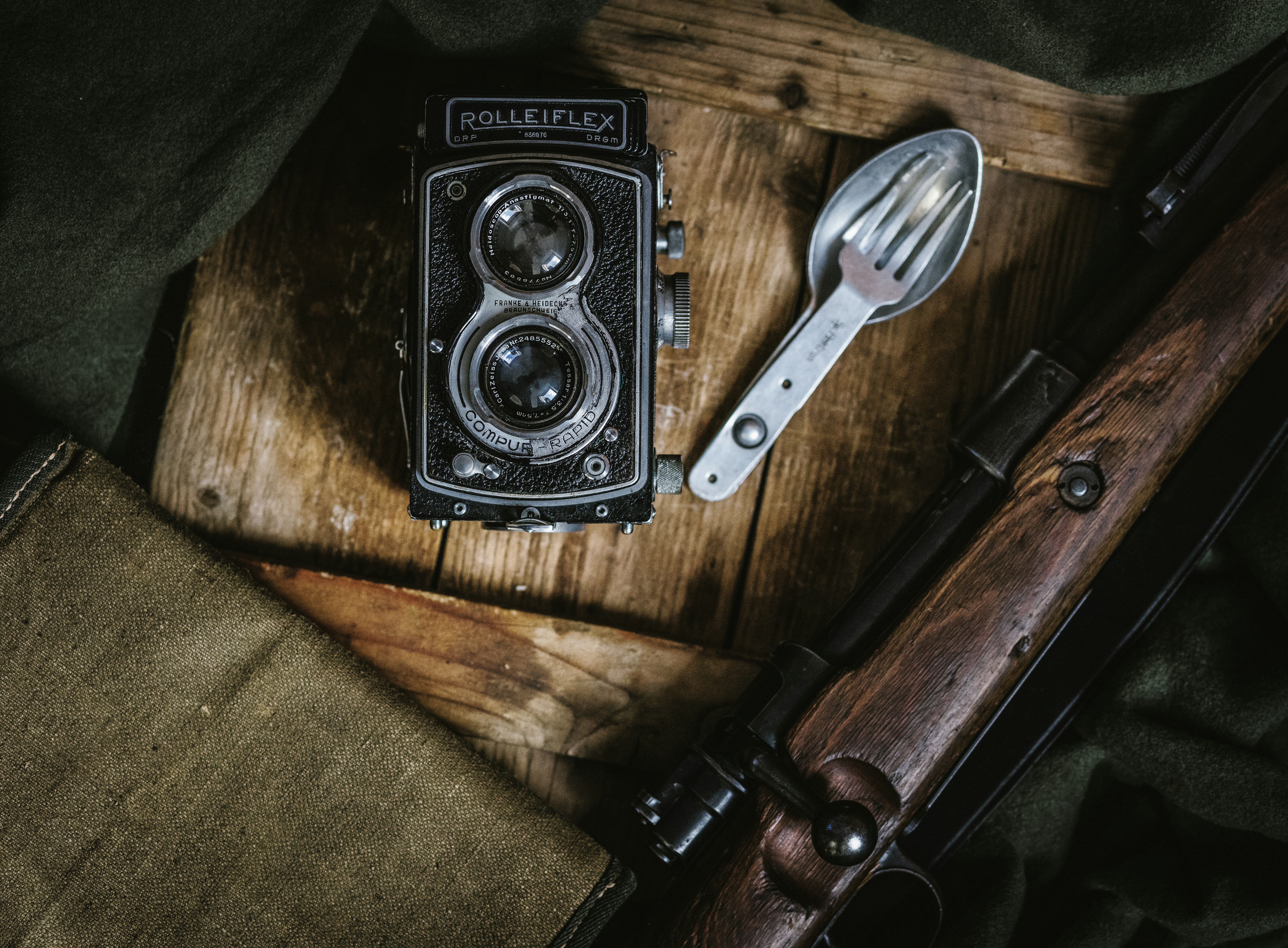 black land camera beside spoon and fork